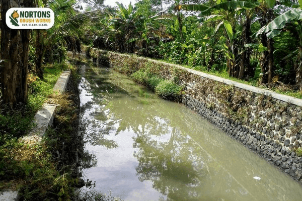 Clean road ditch flowing smoothly without brush or sediment blockages