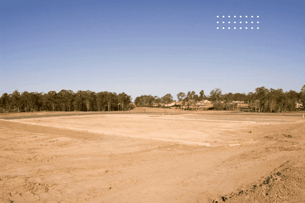 Smoothly graded rural homestead site with proper slope away from foundation