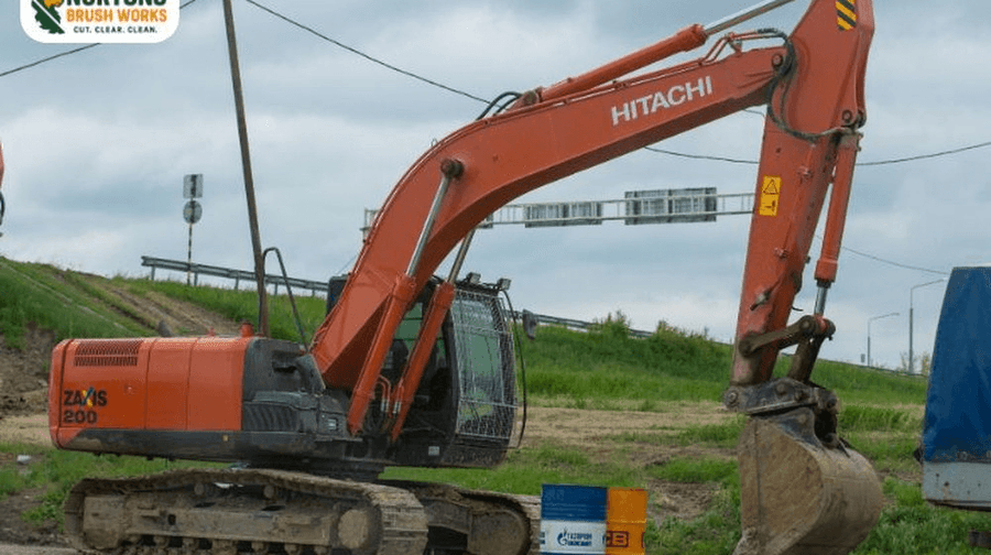 Compact track loader with box blade grading and leveling rough ground for construction site